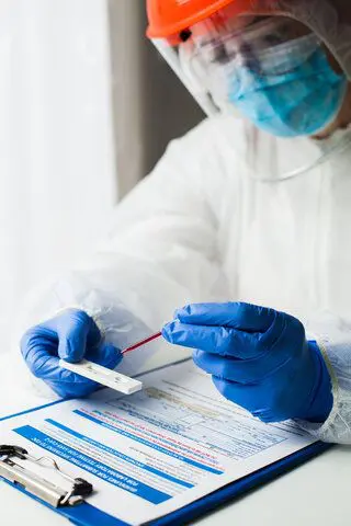 medical professional wearing personal protective gear conducting research